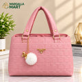 Elegant Pink Women’s Handbag with Gold Accents & Pom-Pom Charm